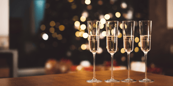 Four champagne glasses in a row