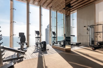 Exercise bike and treadmill equipment with views of sea and sky in background