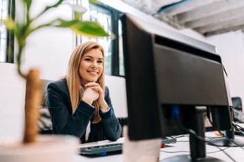Front desk employee sitting behind computer