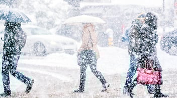 Snowy city with people walking
